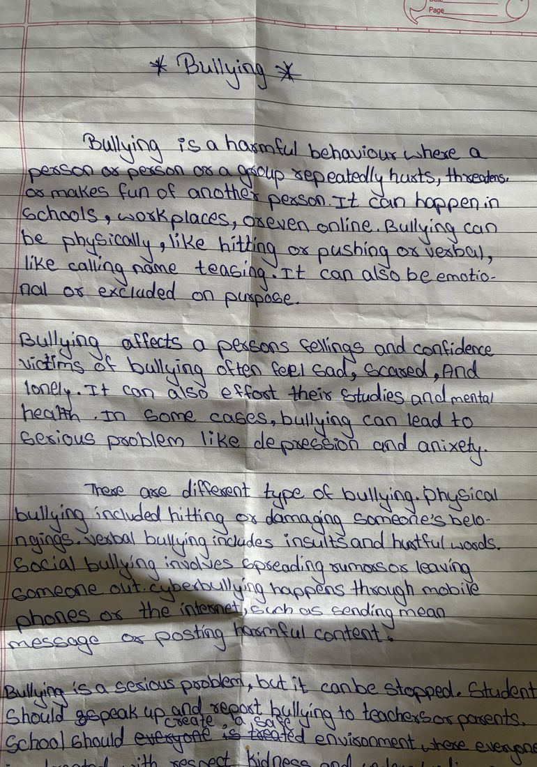 A handwritten sheet headed &ldquo;Bullying&rdquo;, several paragraphs long, describing what bullying is and where it happens